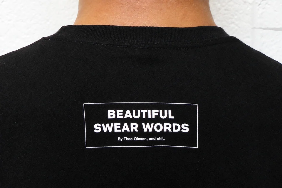 Beautiful Swear Words label printed on the back of a black T-shirt