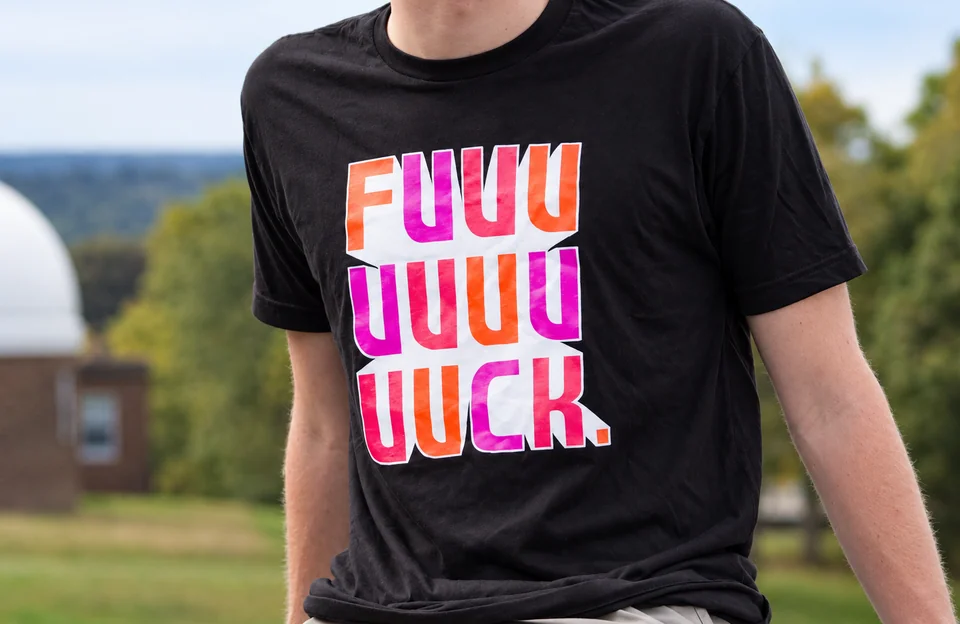 Black T-shirt with stacked pink and orange swear-word lettering