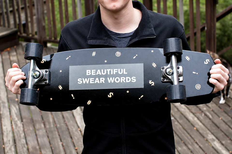 Beautiful Swear Words skateboard underside with logo and punctuation pattern
