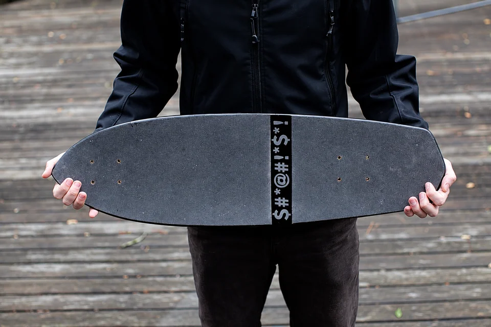Skateboard grip tape with a central strip of punctuation symbols