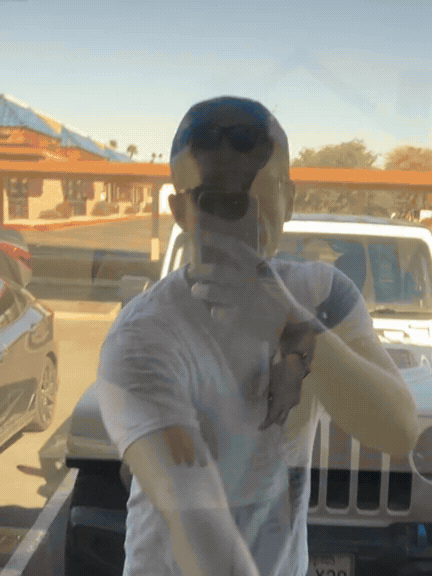 Theo entering the Glow office, revealing Chris and the painted wall logo