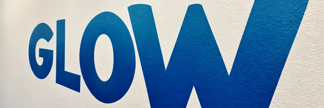 Tight skewed close-up of the blue Glow mural lettering